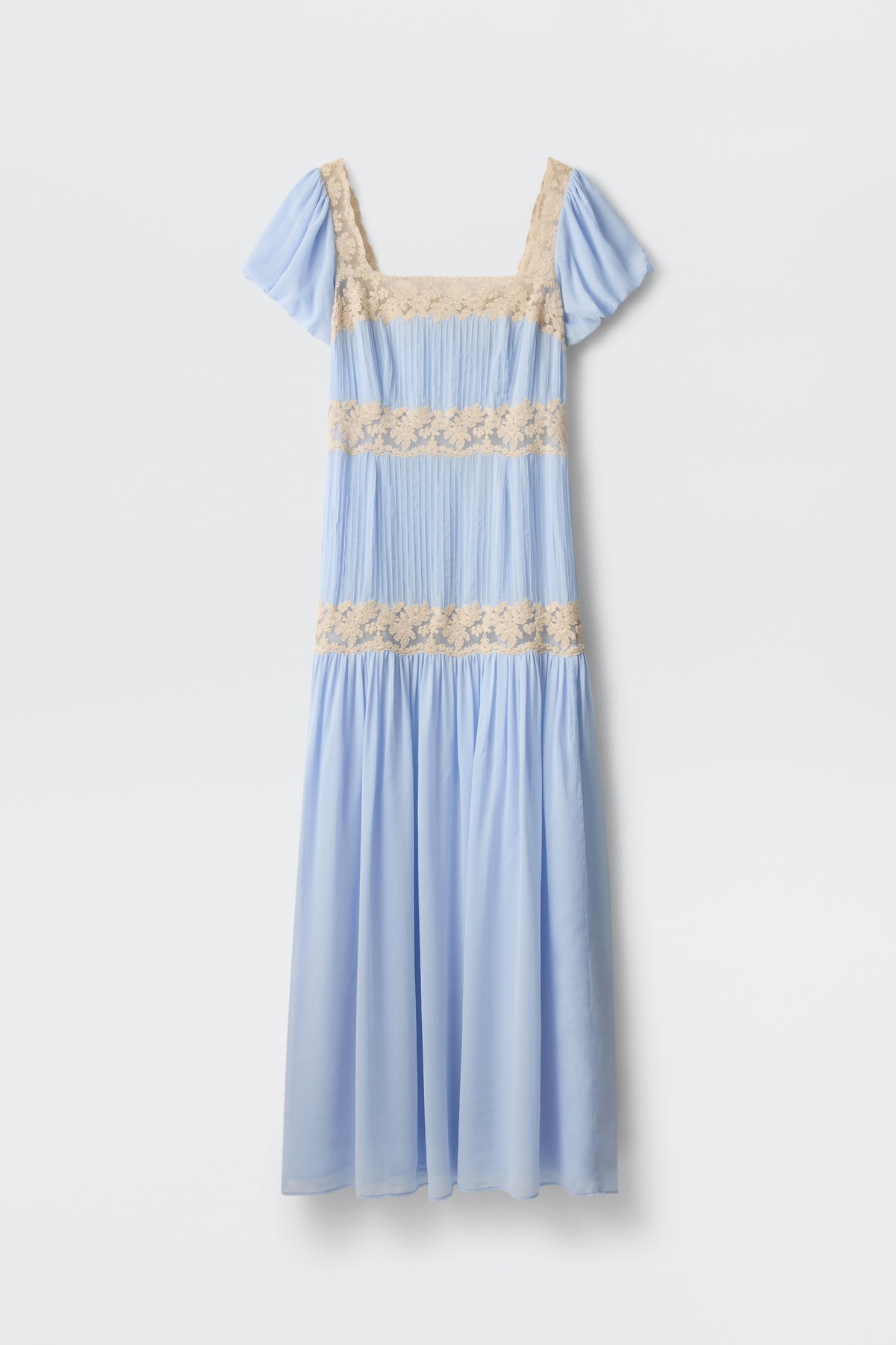 The Marjorie - Vintage Blue is a pastel blue midi dress with short sleeves, a square neckline, and beige lace trim at the chest, waist, and midsection—ideal for romantic occasions. Shown against a plain white background.