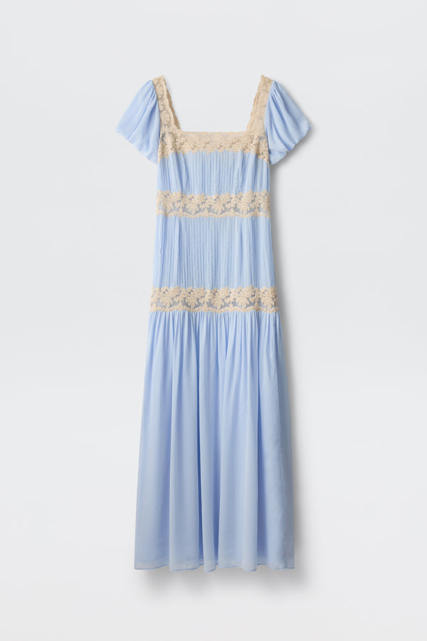 The Marjorie - Vintage Blue is a pastel blue midi dress with short sleeves, a square neckline, and beige lace trim at the chest, waist, and midsection—ideal for romantic occasions. Shown against a plain white background.