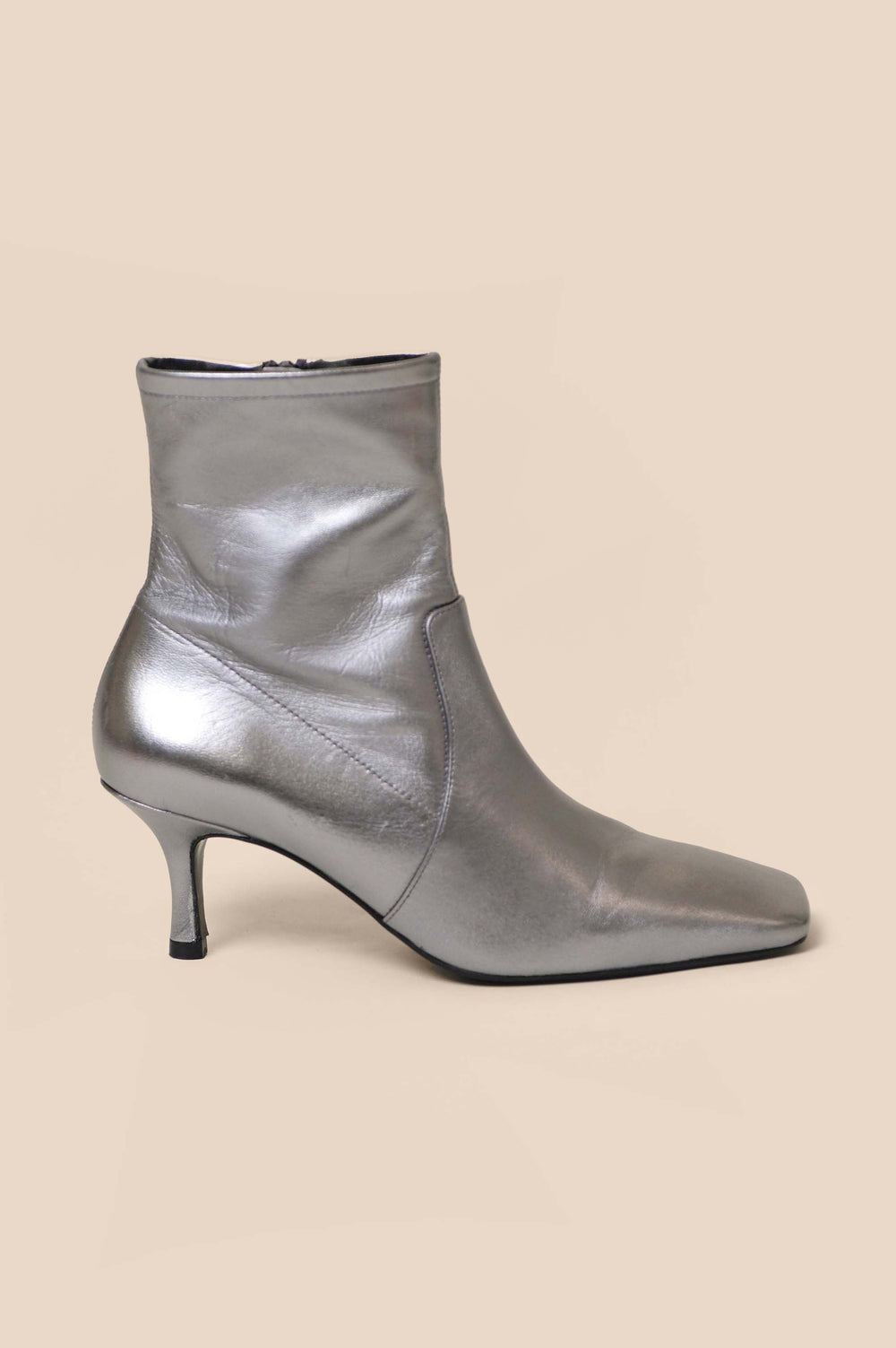 Our Louis ankle boots look precious in pewter, a metallic shade that is both versatile and sophisticated. Use them to elevate jeans or team them with any of RIXO's many hand-painted prints. You may fall for them so hard you wind up building your whole wardrobe around them.